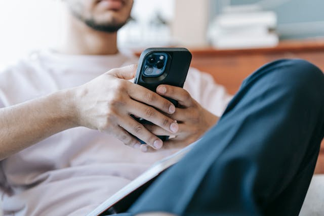 Person holding a cell phone in their hand